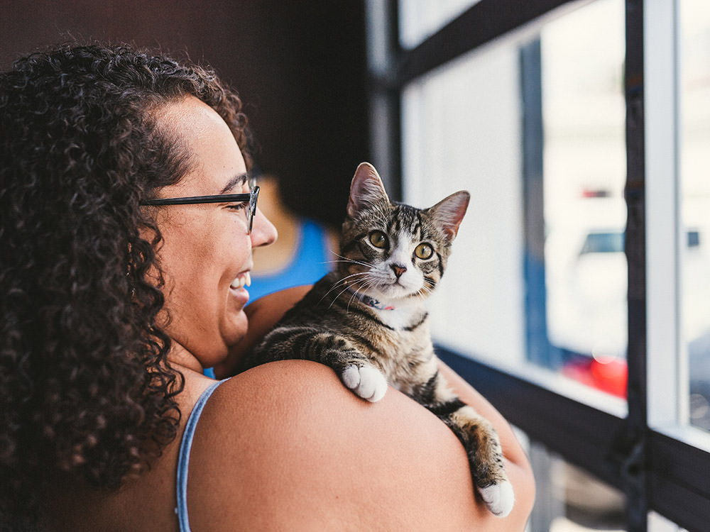 Cat sits on her shoulder