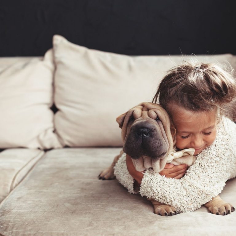 Child hugging her emotional support puppy